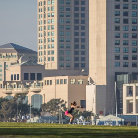 Woman working out on the grass at Embarcadero Marina Park South at the Port of San Diego