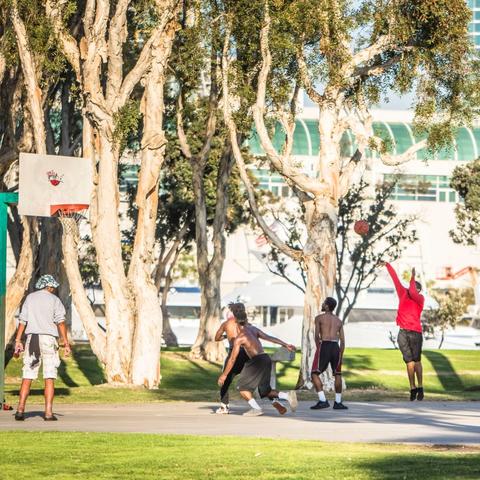People playing at the basketball court at Embarcadero Marina Park South at the Port of San Diego