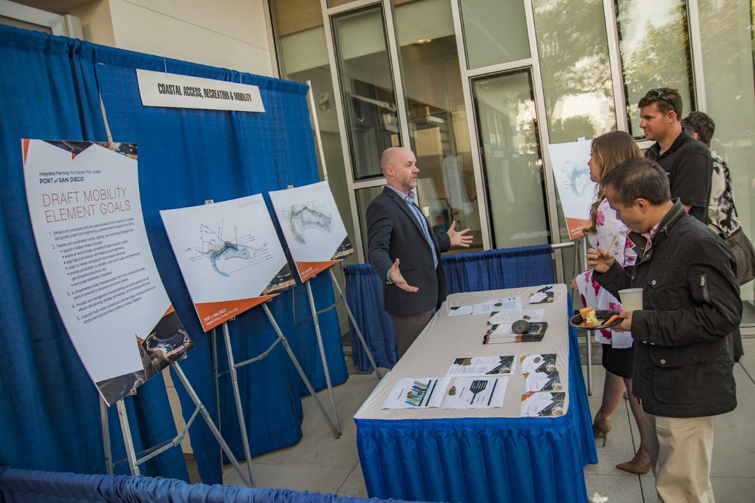 a booth display with people talking to the subject matter expert at a Port of San Diego meeting