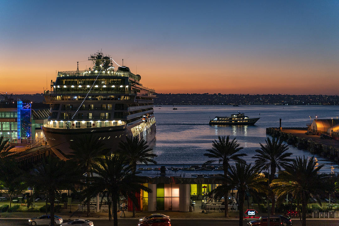 A cruise ship docked at the Port of San Diego at sunset.