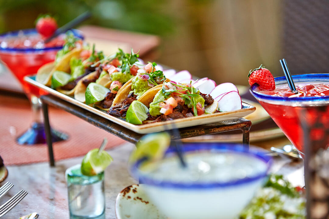 Tequila Bar & Grill shows off a plate of tacos and a margarita