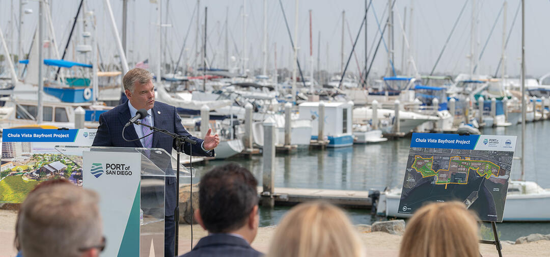 Commissioner Malcolm speaking with the Chula Vista Bayfront behind him