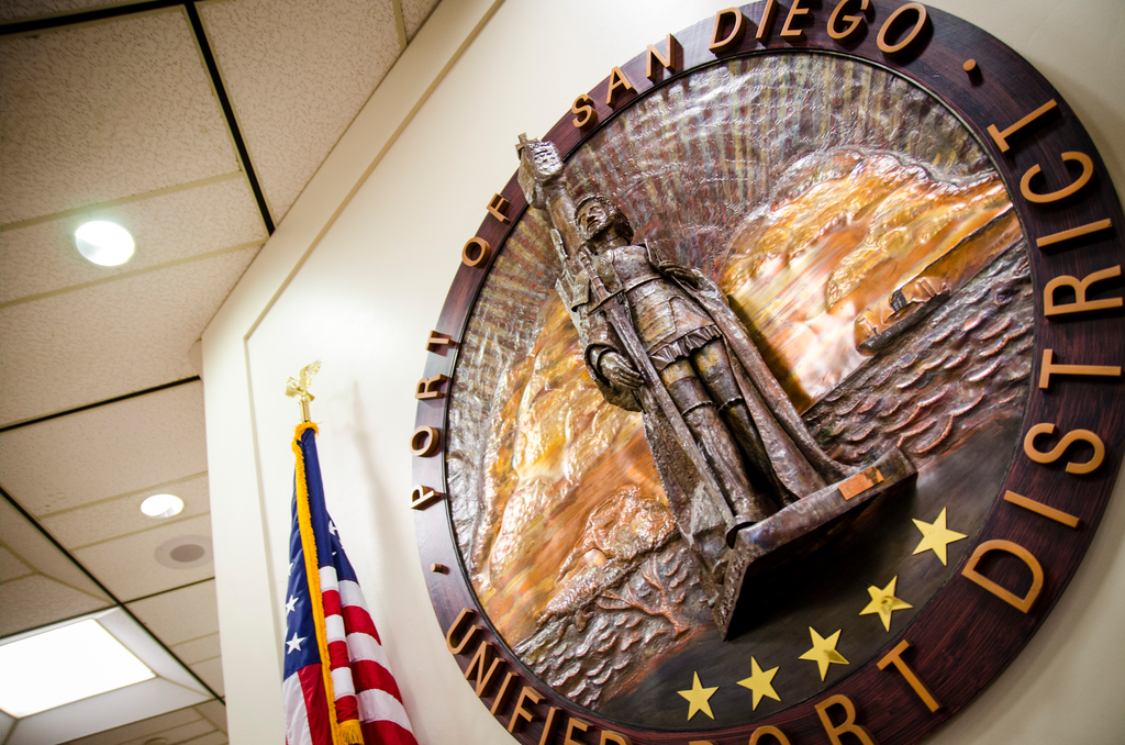 Port seal sculpture and American flag