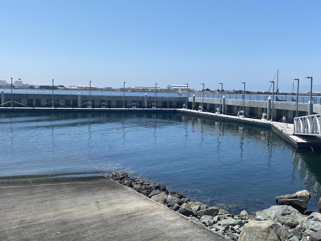 Photo of west side floating docks at Shelter Island Boat Launch ramp with caution tape and closure signs.