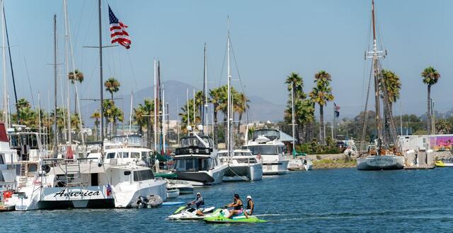 Image of jet skiers in San Diego Bay near Chula Vista with boats docked at the marina.