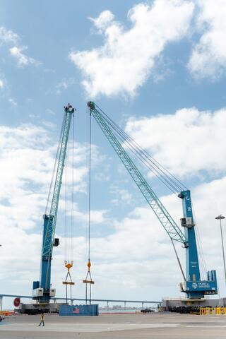 The Port of San Diego's new all-electric mobile harbor cranes perform a tandem lift during a demonstration event on September 17, 2024.