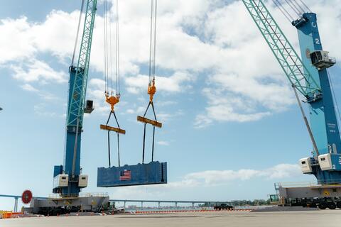 The Port of San Diego's new all-electric mobile harbor cranes perform a tandem lift during a demonstration event on September 17, 2024.