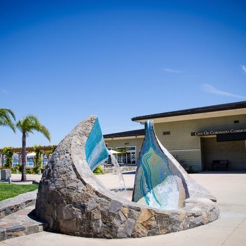 a mosaic fountain by the artist James T. Hubbell rises from the concrete and has blue tone tiles on the inside