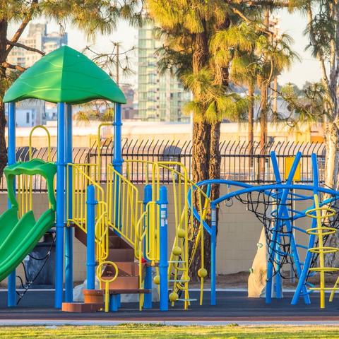 Playground with slides, steps, ladders, nets, and mini rock climbing walls at Cesar Chavez Park at the Port of San Diego 