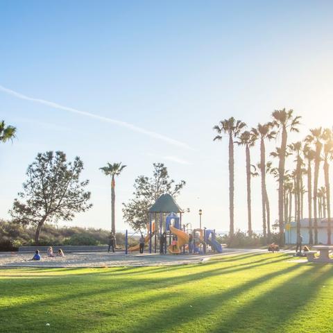 Playground, trees, sand, and grass at Chula Vista Marina View Park at the Port of San Diego