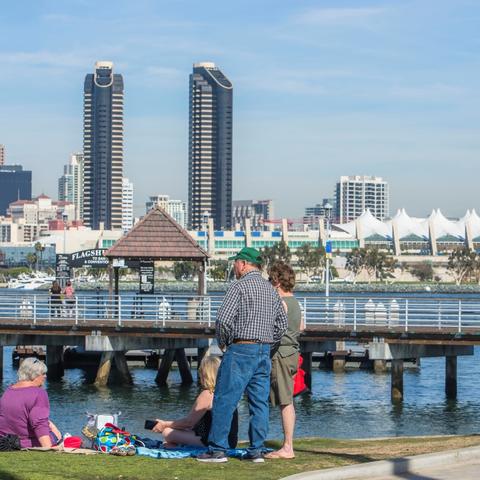 Family on grass at Coronado Landing Park at the Port of San Diego