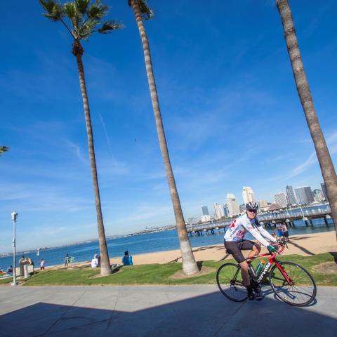 Cyclist riding along Coronado Landing Park at the Port of San Diego
