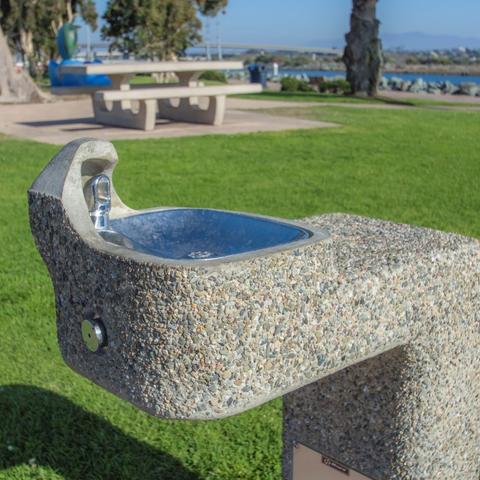 Drinking water fountain surrounded by luscious, green grass at Pepper Park at the Port of San Diego