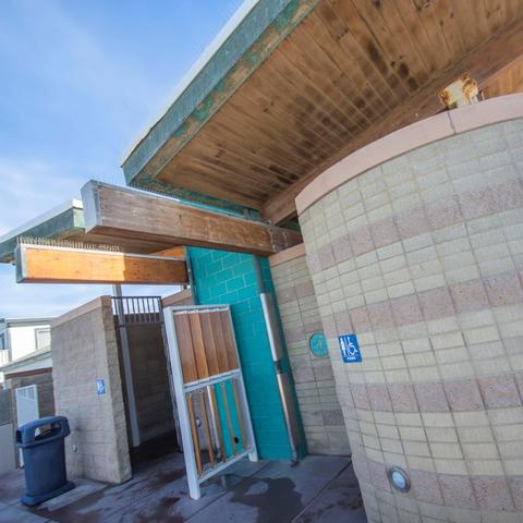 Restroom with cylindrical tile exterior and wooden roof at Portwood Pier Plaza at the Port of San Diego