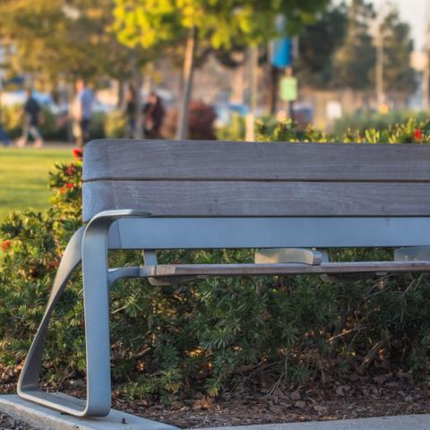 Bench in front of flower bush at Ruocco Park at the Port of San Diego