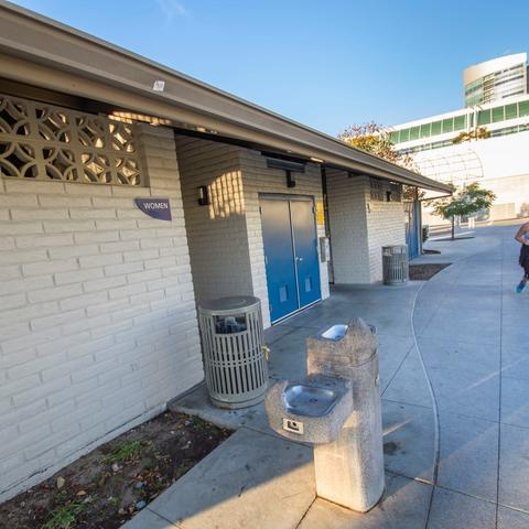 Restroom with white brick exterior and drinking water fountains at San Diego Bayfront Park at the Port of San Diego